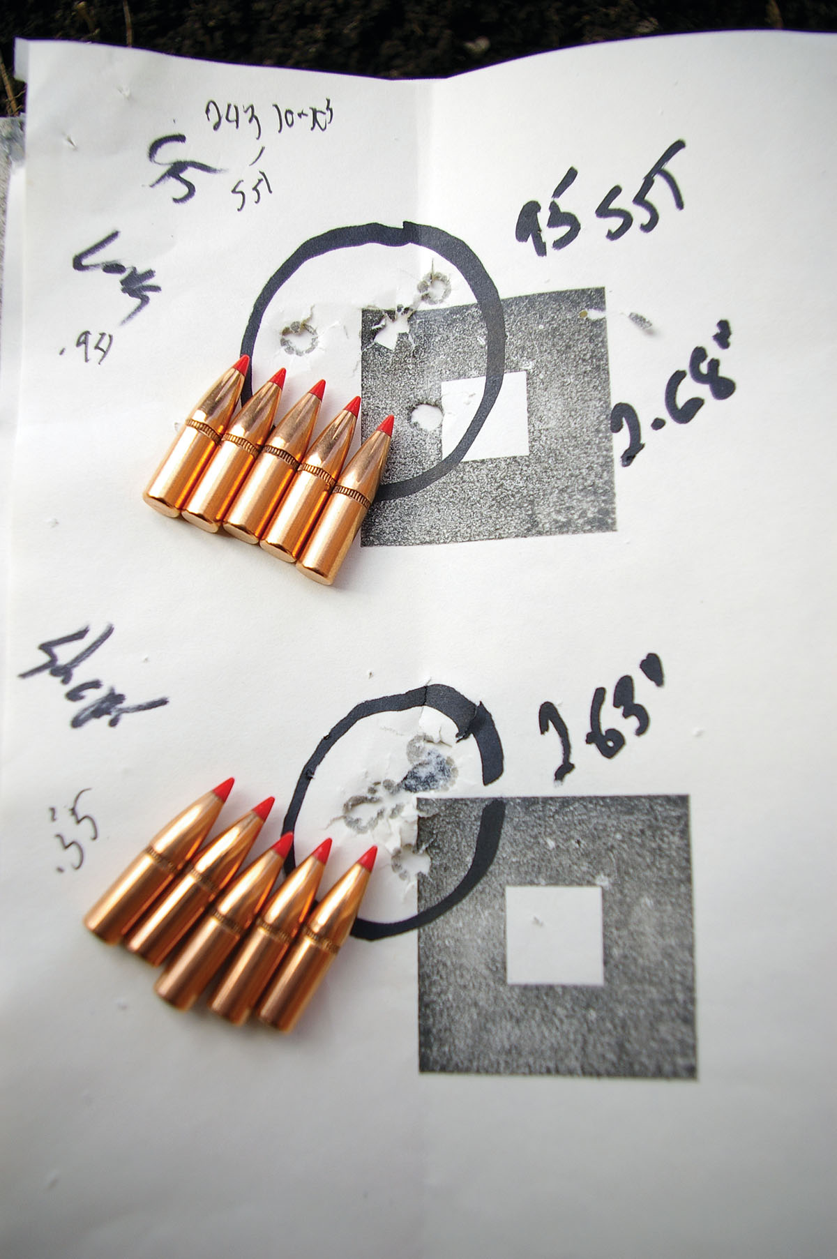 The top group was fired with Hornady 95-grain SST bullets seated in  .243 Winchester cases just short of contacting the rifling in a Cooper Arms Model 22. The bottom group was shot with the same bullets seated to a shorter cartridge overall length. Deeper seating produced better results.